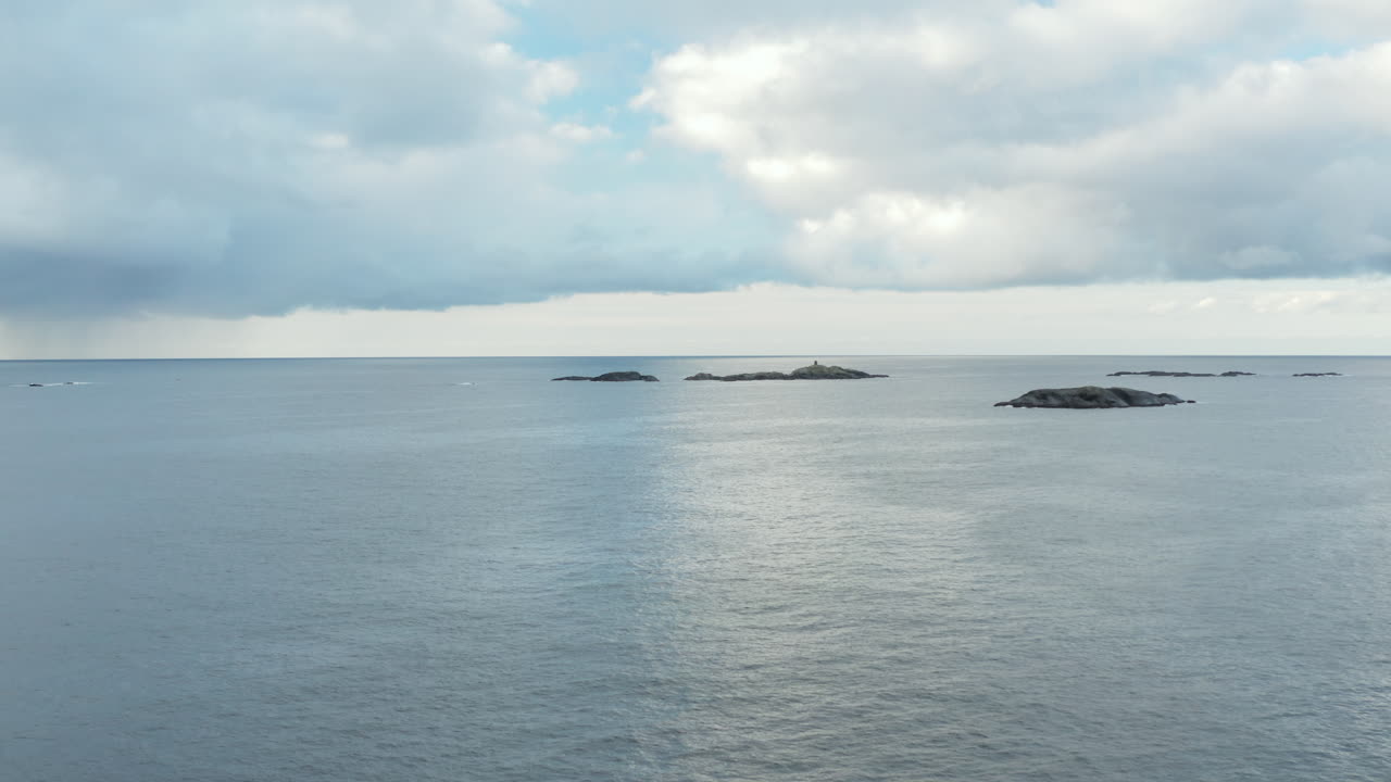 Serene Seascape: Small Islands in a Calm Ocean Under an Overcast Sky
