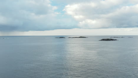 serene seascape: small islands in a calm ocean under an overcast sky