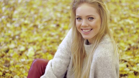 Smiling-woman-sitting-on-ground