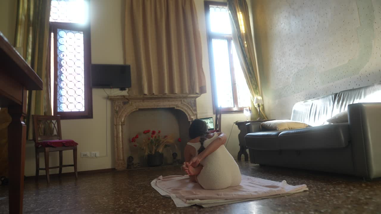 Woman practicing yoga in a Venetian apartment