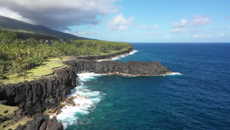 aerial view over the lava rock formation of cap mechant and the coastline of reunion island