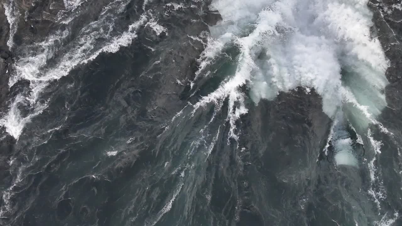 Overhead drone view of Selfoss waterfall in Iceland with intense water flow and crashing waves.