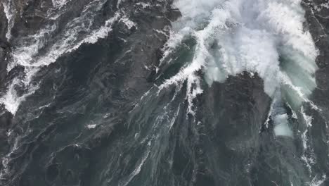 overhead drone view of selfoss waterfall in iceland with intense water flow and crashing waves.