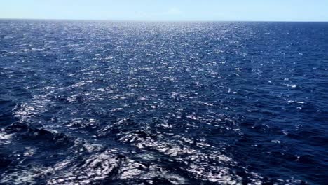 wide view of the ocean waves as the sun reflects on the frothy rolling waters segment 2 of 2