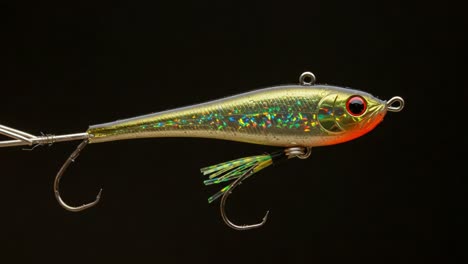 shimmering fishing lure with iridescent finish captured in two frames, displaying the craftsmanship and appeal of modern bait designs for anglers