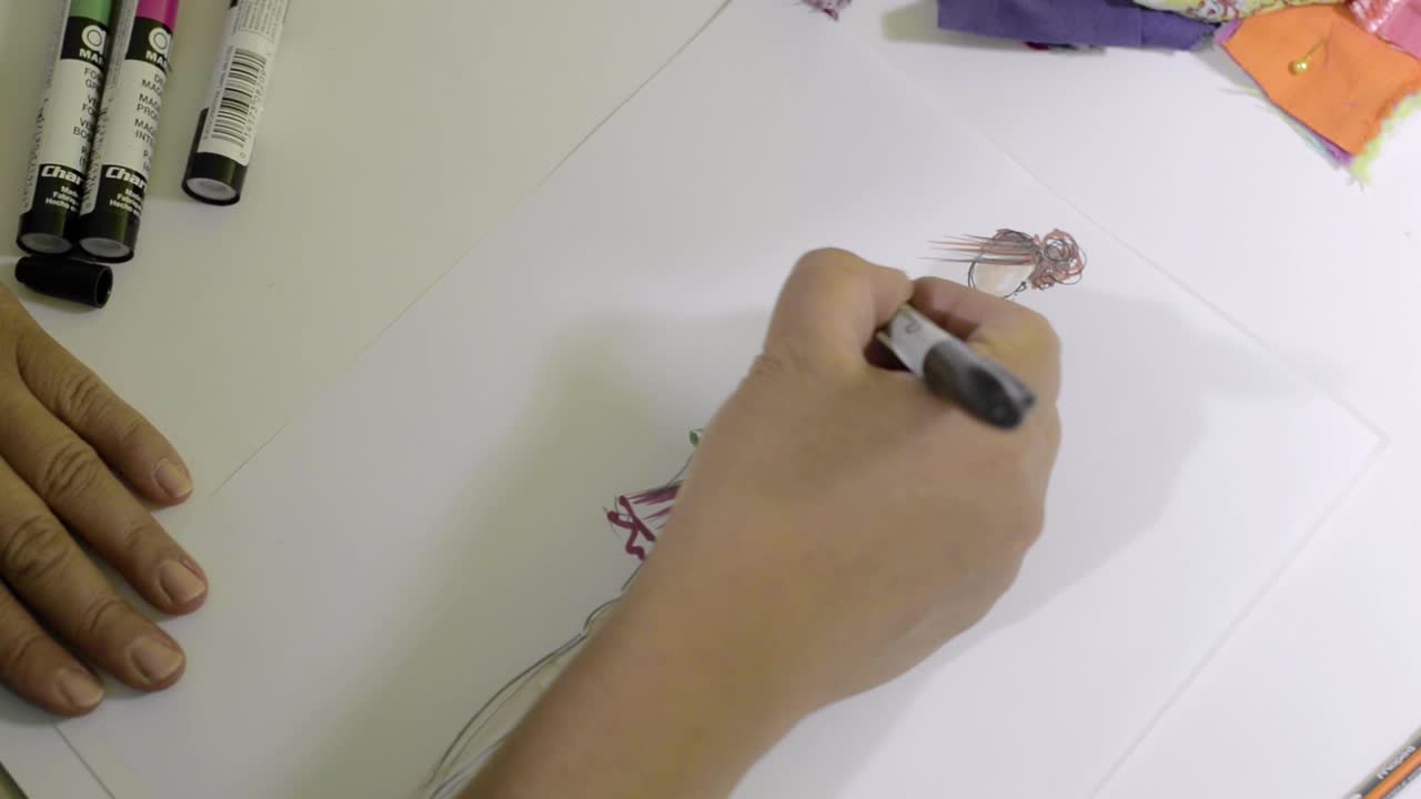 Latin fashion designer drawing and creating a new model for her collection