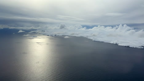 aerial helicopter view of a magnificent coastline in finnmark during a calm winter day in the arctic