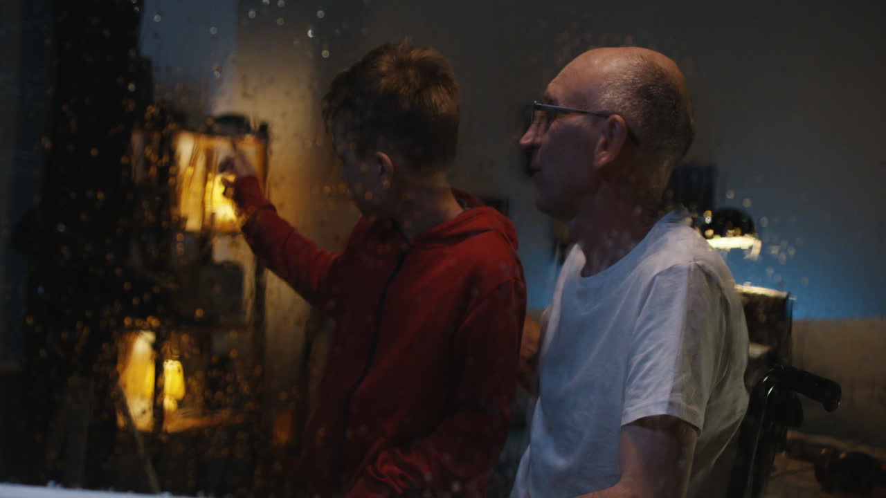 Grandfather and Grandson Watching Rain at Night
