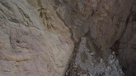 drone pannen omhoog van rotsachtig kiezelstrand naar kliffen en bergen aan de kust van californië in de buurt van big sur