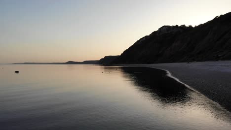 calm tranquil sunset waters beside littlecombe shoot beach