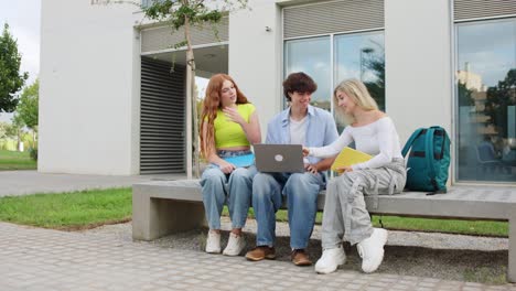 Students working on a laptop on campus