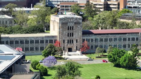 aerial telephoto shot of uq's great court and forgan smith building, with camera drone rotating around main building from a large distance away