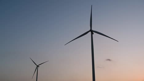 wind turbines silhouette against the blue-sky during sunset, clean alternative energy in thailand and mainland southeast asia