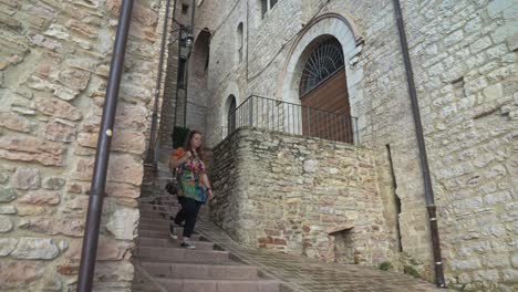 portrait of a woman touring on the historic hill town of assisi in umbria, italy