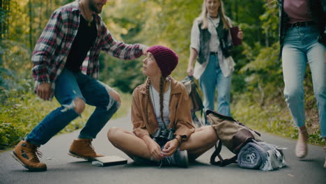 friends surprising young woman sitting in forest