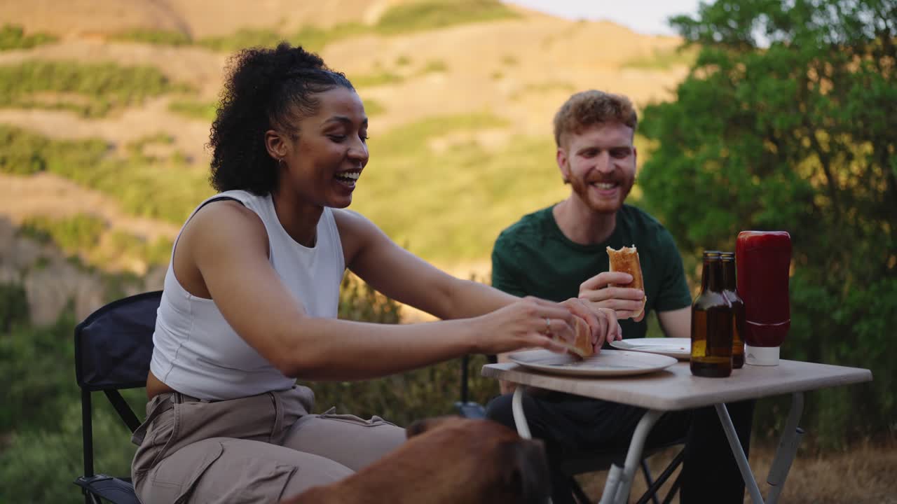 People having a picnic outdoors with their dog