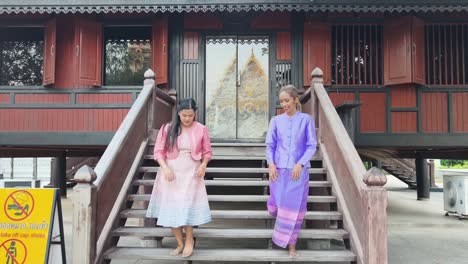 thai women in traditional clothing at a temple