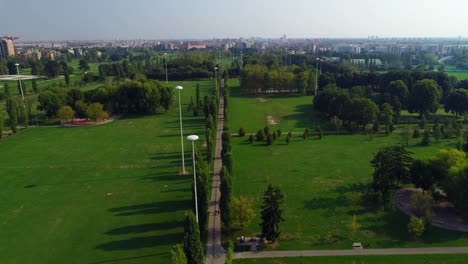 Aerial-view-of-countryroad-through-green-field-4k