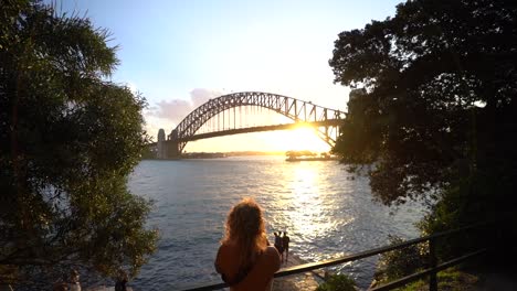 girl taking photos sydney harbor bridge sunset slow motion