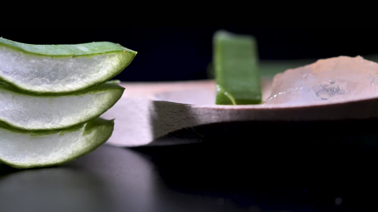 Fresh Aloe Vera Sliced on the black background, green herb concept for cosmetic and skincare product presentation, round smooth motion. Scene G