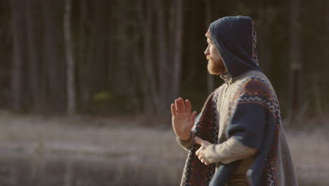 An-ice-bathing-handsome-bearded-man-warming-up-doing-qigong-tai-chi-before-going-in