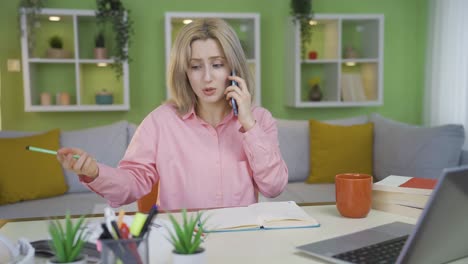 the university student girl talking to her friend on the phone cannot solve the lesson question.
