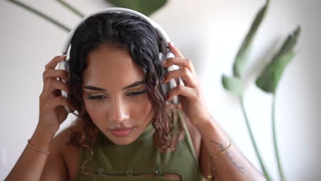 woman putting on headphones