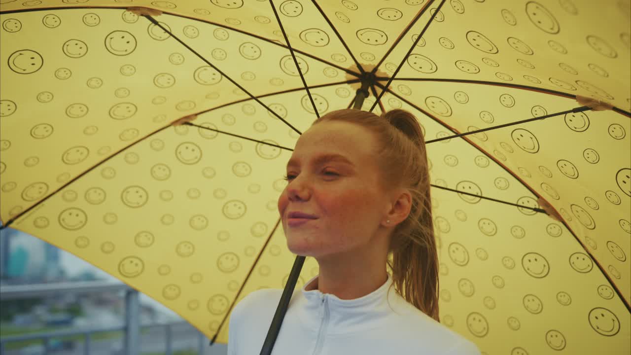 Woman with a yellow umbrella in the rain