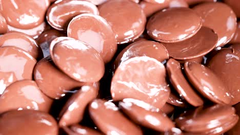 chocolate discs cascading into a pile