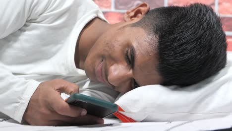 teenager using smartphone in bed