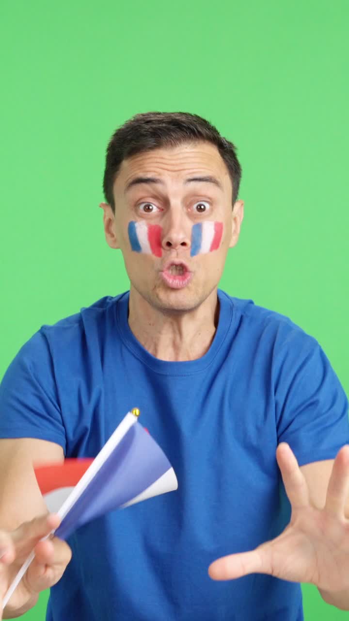 Passionate french supporter screaming and waving a national flag