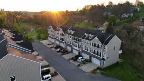 new tan brown townhouse homes in a row at sunrise