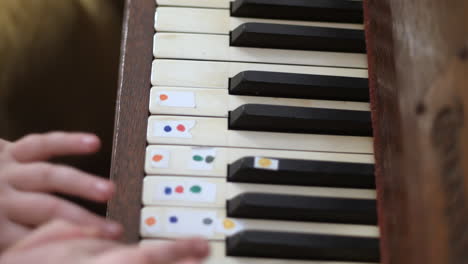 top view of a young girl's fingers as she is learning to play the piano