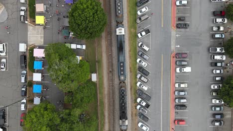 a train moving through a downtown shopping area