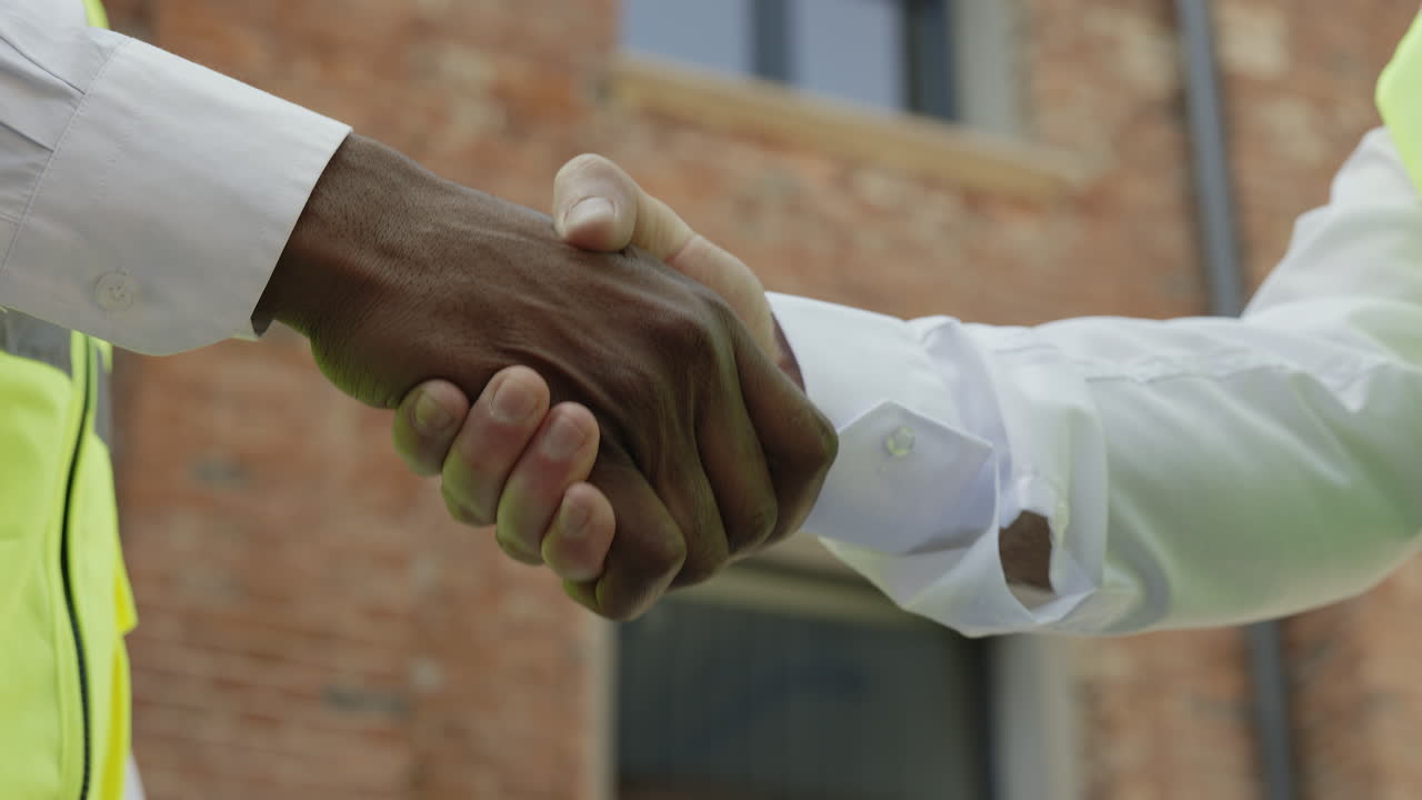 Business handshake at a construction site