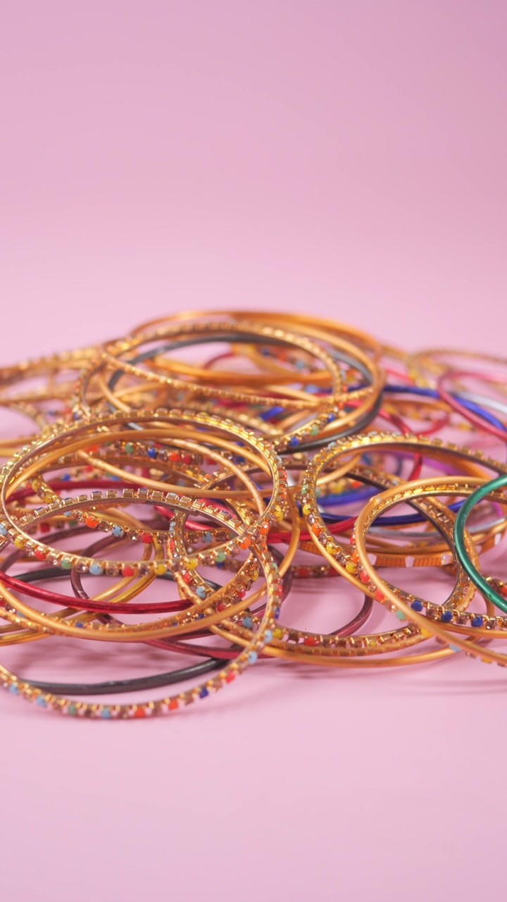Close-up of Vibrant Indian Bangles on Pink Background