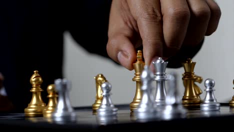 hand of business man and woman playing chess