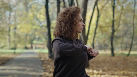 ginger woman warming up at the park in autumn