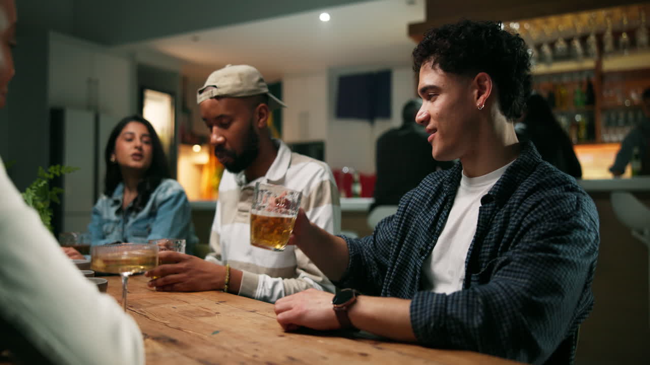 Group of friends drinking beer at a bar