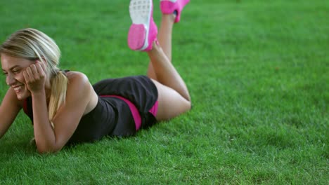 young woman making video chat on mobile phone in park. sport woman