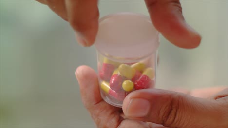 close-up-of-the-hand-covering-the-drug-capsule