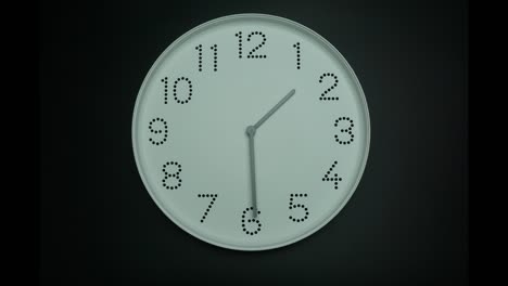 time lapse  white wall clock tells the time at 2 p.m.