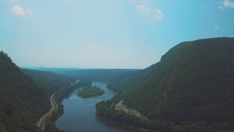 Aerial-shot-of-a-highway-by-the-riverside