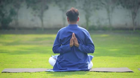 hombre indio haciendo la postura inversa de yoga namaste