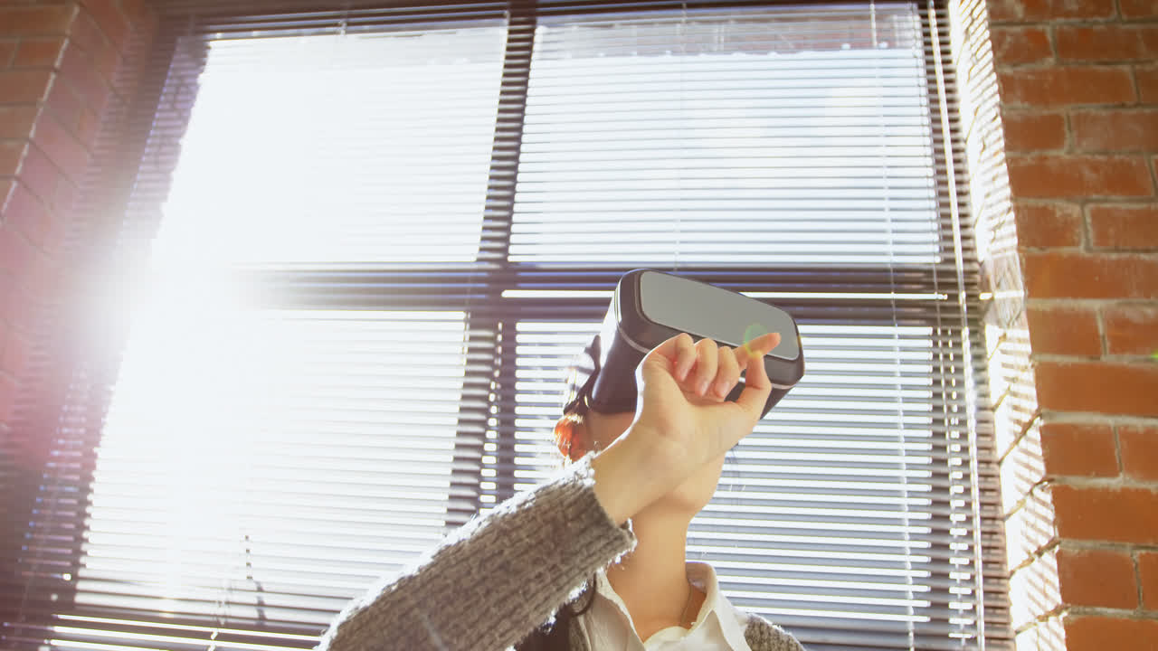 Female executive using virtual reality headset 4k