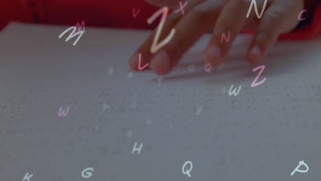 animation of looping letters over cropped hand of blind student reading book in classroom