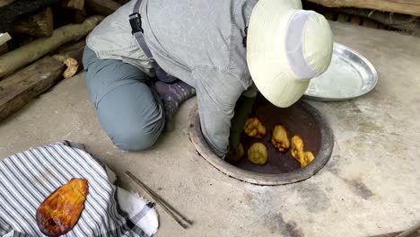 Young-woman-bake-golden-fresh-hot-flat-sweet-Persian-nomad-local-people-delicious-bread-like-fluffy-cookies-and-cake-with-garnish-sesame-yolk-egg-crispy-skin-in-clay-round-circle-oven-in-village-life