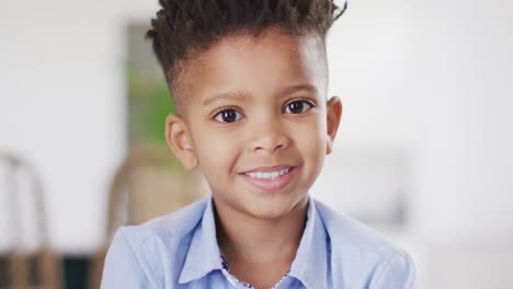 portrait of happy african american boy looking at camera and smiling