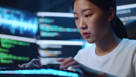 focused young developer engaged in coding tasks amidst a high-tech environment featuring colorful screens and complex data visualizations