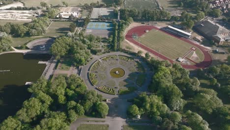 Italian Gardens and running track with woodlands on sunny day. Stanley Park, Blackpool, Lancashire, UK.
